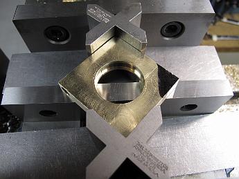  Clamping setup #1 to machine the ram mount--a failure.  This setup shifted the two halves of the strap, removing our ability to indicate the hole to find the center, which is needed for the next machining operation.  If you look closely, you can see parting line in the eccentric hole showing how the two parts have shifted.